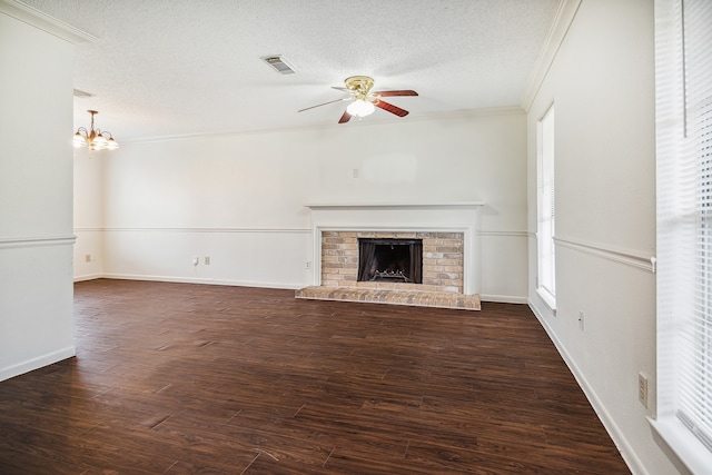 unfurnished living room featuring a fireplace, dark hardwood / wood-style flooring, ornamental molding, and a textured ceiling