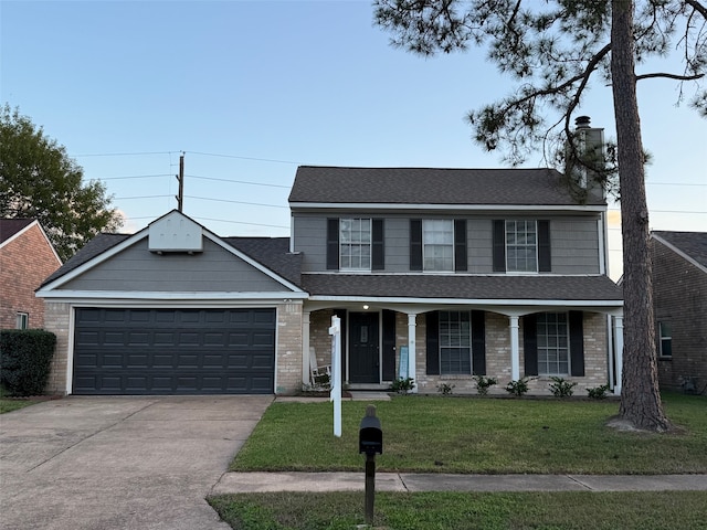 view of front of house featuring a front lawn, a porch, and a garage