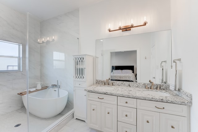 bathroom featuring shower with separate bathtub and vanity