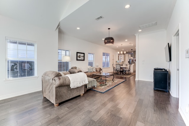 living room featuring hardwood / wood-style floors, an inviting chandelier, and plenty of natural light