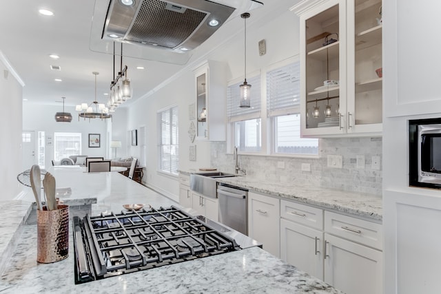 kitchen featuring white cabinetry, sink, light stone countertops, pendant lighting, and appliances with stainless steel finishes