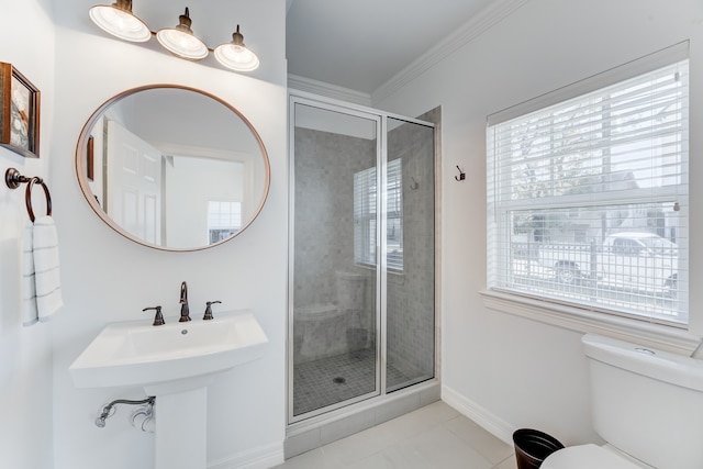 bathroom with crown molding, tile patterned flooring, a shower with shower door, and toilet