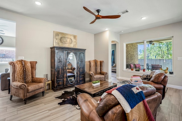 living room featuring light hardwood / wood-style floors and ceiling fan