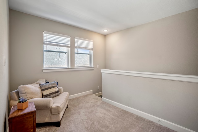 sitting room with light colored carpet