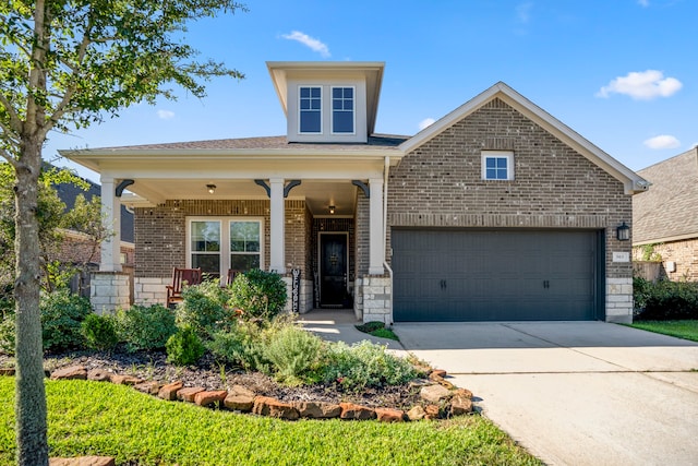 view of front of home featuring a porch and a garage