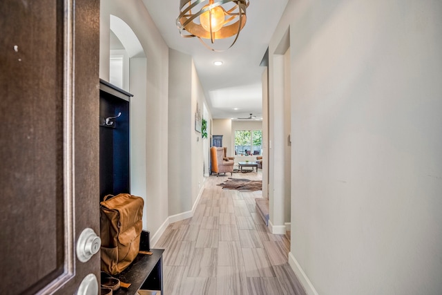 hall featuring an inviting chandelier