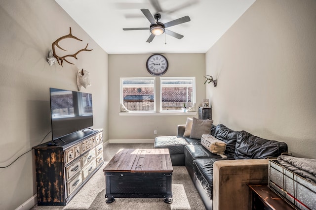 living room with ceiling fan and carpet