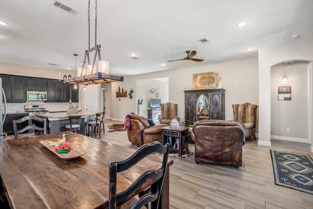 dining room with ceiling fan and light hardwood / wood-style floors