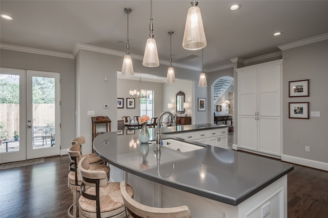 kitchen with white cabinets, decorative light fixtures, plenty of natural light, and sink