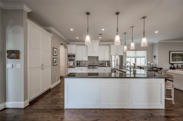 kitchen featuring a spacious island, dark hardwood / wood-style floors, white cabinetry, hanging light fixtures, and stainless steel refrigerator