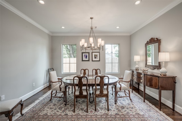 dining area featuring an inviting chandelier, wood-type flooring, and ornamental molding