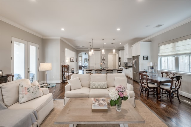 living room with crown molding, french doors, and hardwood / wood-style flooring