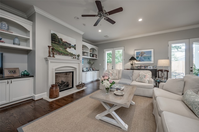 living room with a wealth of natural light, crown molding, and dark wood-type flooring