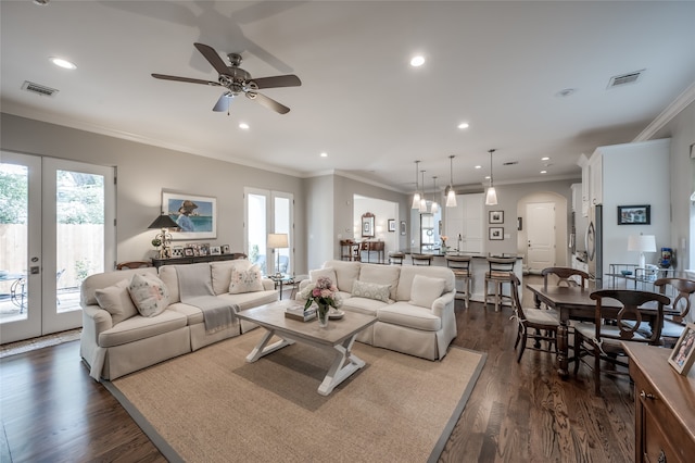 living room with crown molding, dark hardwood / wood-style flooring, ceiling fan, and french doors