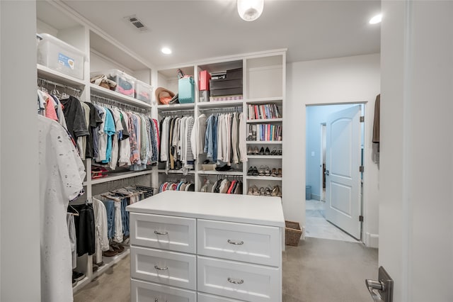 spacious closet with light carpet