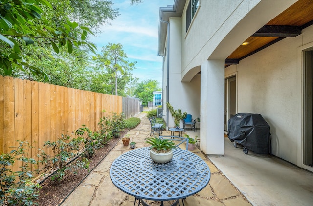 view of patio / terrace featuring central AC unit and grilling area