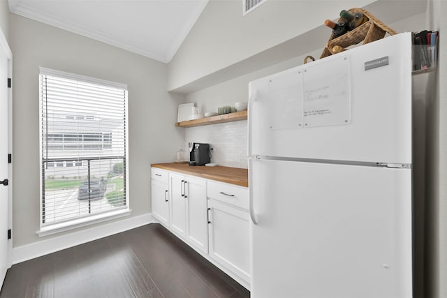 kitchen with lofted ceiling, dark wood-type flooring, white refrigerator, butcher block countertops, and white cabinetry