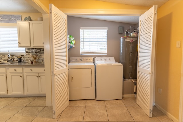 laundry area with sink, water heater, a textured ceiling, washer and clothes dryer, and light tile patterned flooring