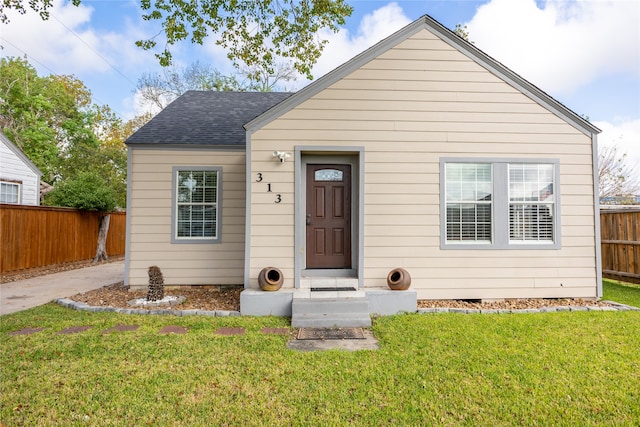 bungalow-style home featuring a front lawn