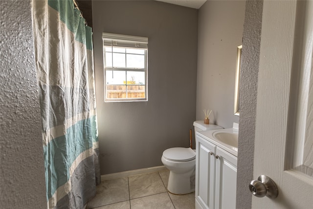 bathroom with tile patterned floors, vanity, and toilet