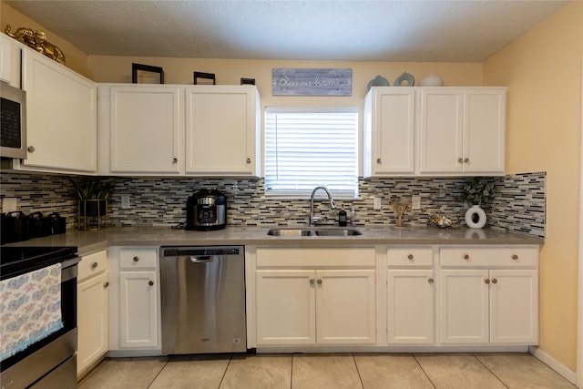 kitchen with white cabinets, appliances with stainless steel finishes, and sink