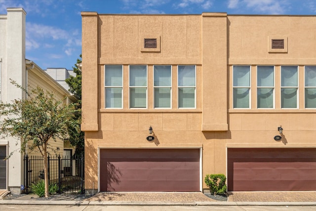 townhome / multi-family property featuring a garage