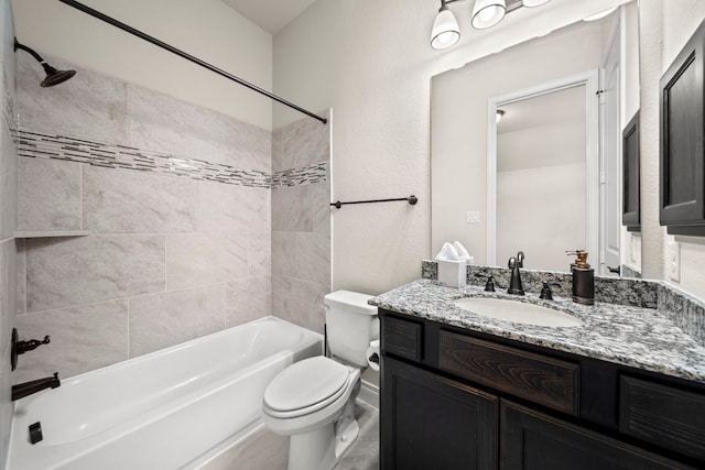 full bathroom featuring tiled shower / bath combo, toilet, and vanity