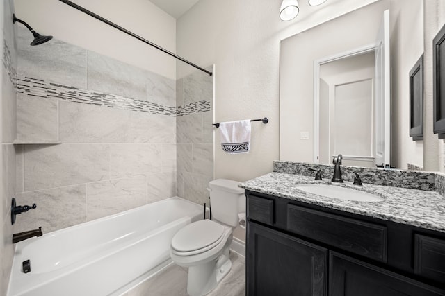 full bathroom featuring vanity, tiled shower / bath combo, and toilet