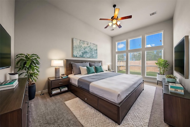 carpeted bedroom featuring a high ceiling and ceiling fan