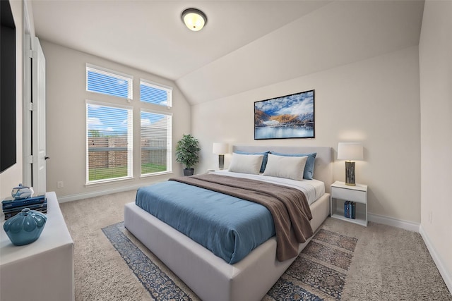 bedroom with carpet flooring and lofted ceiling