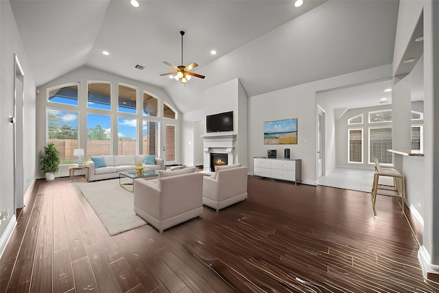 unfurnished living room featuring dark hardwood / wood-style floors, high vaulted ceiling, and ceiling fan