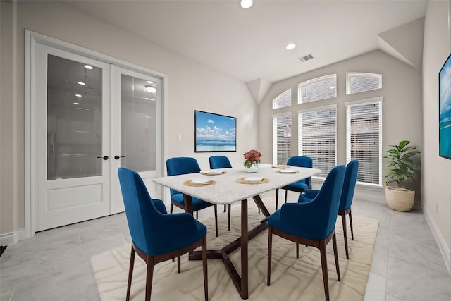 dining area with french doors and lofted ceiling