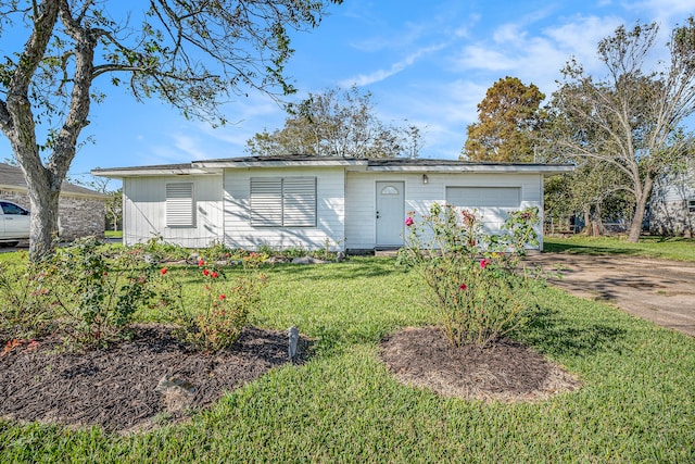 ranch-style house with a garage and a front yard