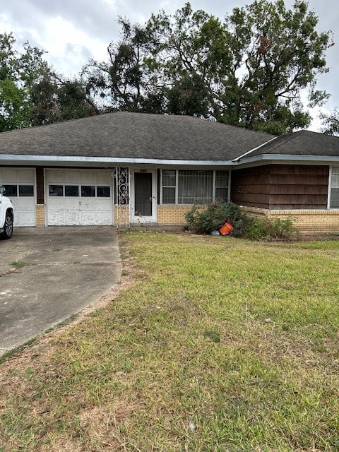 ranch-style home with a front lawn and a garage