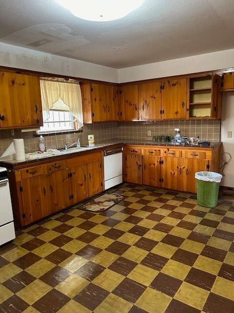 kitchen featuring white appliances, tasteful backsplash, and sink