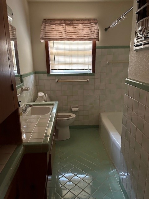 bathroom with tile patterned floors, tile walls, and toilet