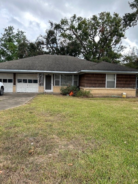 single story home with a front yard and a garage