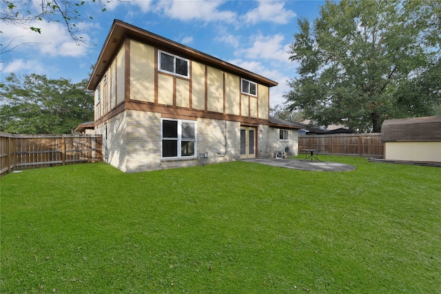 rear view of property featuring a patio area and a yard