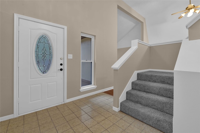 entryway featuring light tile patterned floors and ceiling fan