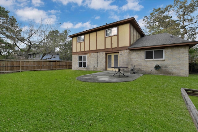 rear view of house featuring a yard and a patio area