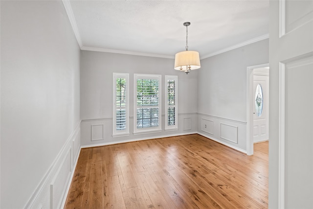 unfurnished room with crown molding and hardwood / wood-style flooring