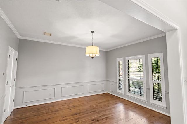 empty room with hardwood / wood-style floors and ornamental molding