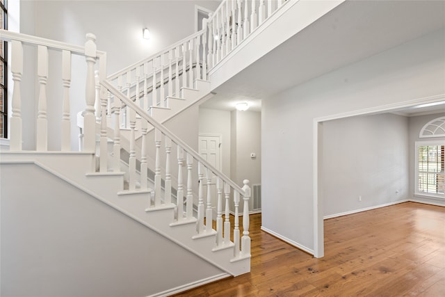 stairs with hardwood / wood-style floors