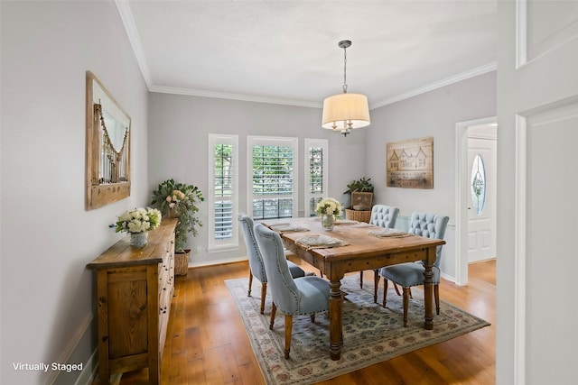 dining room featuring hardwood / wood-style floors and ornamental molding