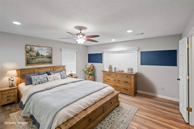 bedroom featuring hardwood / wood-style floors and ceiling fan