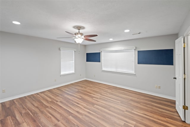 unfurnished room with hardwood / wood-style floors and ceiling fan