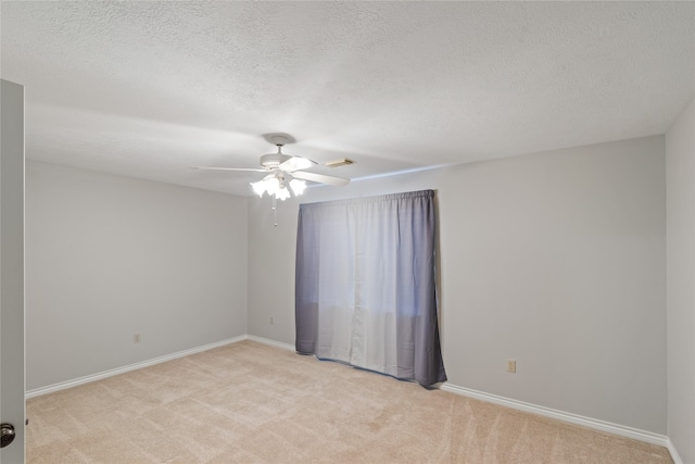 carpeted empty room featuring a textured ceiling and ceiling fan