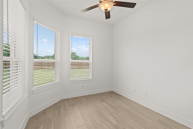 unfurnished room featuring light wood-type flooring, plenty of natural light, and ceiling fan