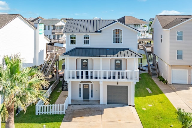 view of front facade featuring a balcony, a garage, and a front lawn