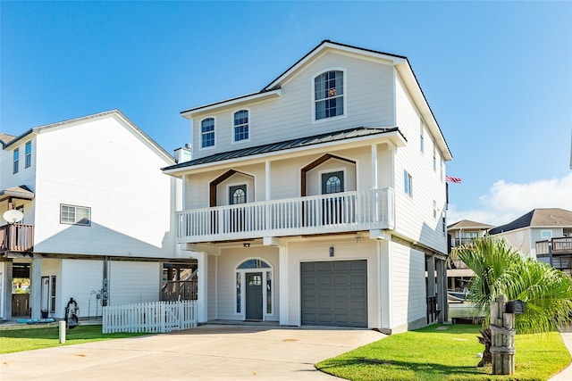 view of front of property featuring a garage and a balcony